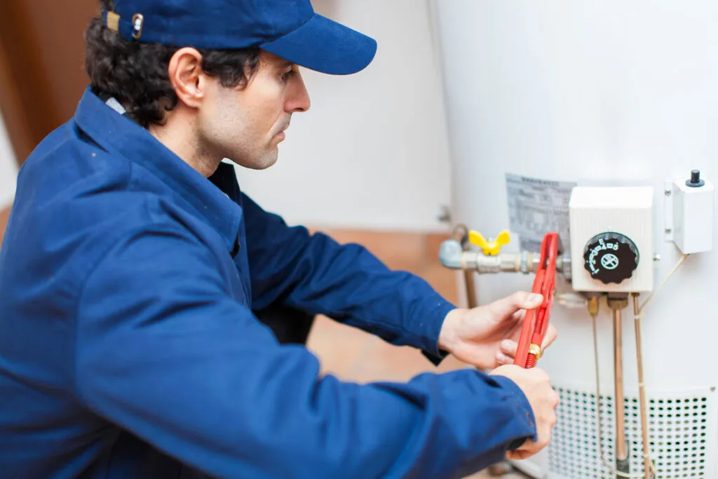 professional repairing a water heater